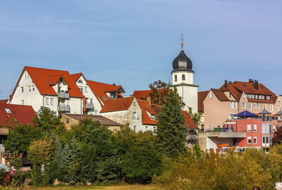 Buildings in town against sky