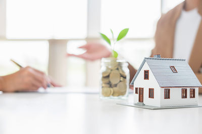 Midsection of woman holding toy on table