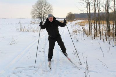 Full length of man skiing on snow field