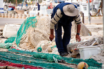 Rear view of man working at market