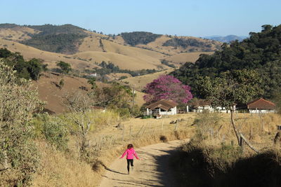 Rear view of people walking on mountain