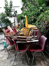 Empty chairs and table in yard