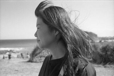 Portrait of young woman looking at beach