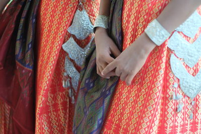 Midsection of woman in red traditional clothing