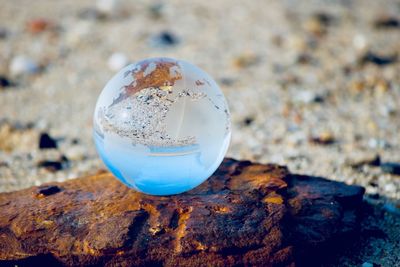 Close-up of crystal ball on rock