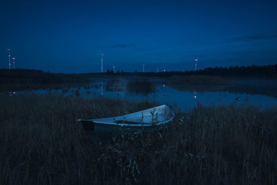 Scenic view of lake against blue sky at dusk