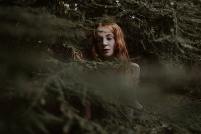 Portrait of a beautiful young woman in forest