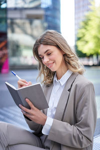 Portrait of young businesswoman using laptop