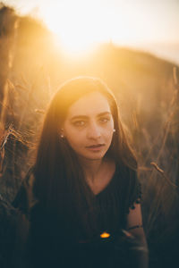 Portrait of beautiful young woman at sunset