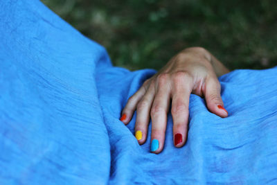 Close-up of woman with multi colored nail polish