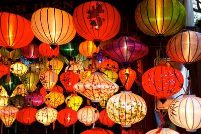 Low angle view of illuminated lanterns hanging at night