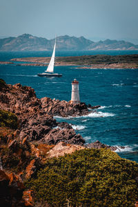 Sailboat sailing on sea against sky