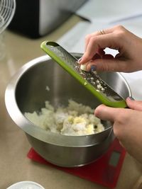 Midsection of man preparing food in bowl on table