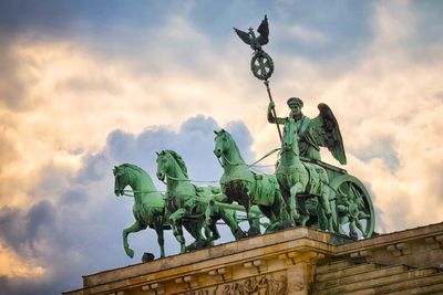 Low angle view of statue against cloudy sky