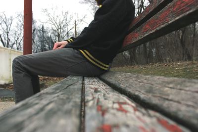 Woman standing on tree trunk