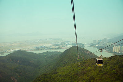 Overhead cable car on mountain against sky
