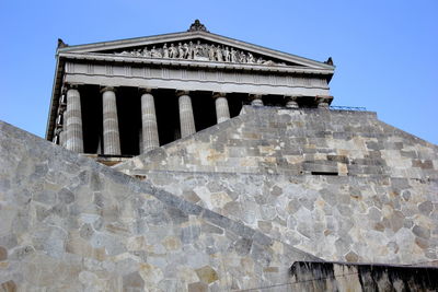 Low angle view of old ruins against clear blue sky