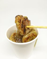 Close-up of food in bowl against white background