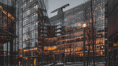 Low angle view of illuminated modern buildings at night
