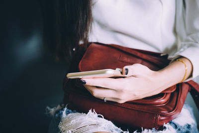 Close-up of woman holding mobile phone