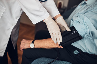 Doctor carying out blood pressure test and heart rate of senior man. checking health condition