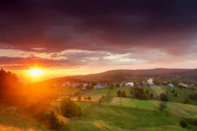 Scenic view of landscape against sky during sunset
