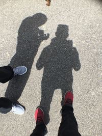 Low section of people standing on tiled floor