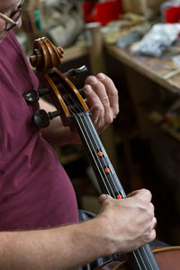 Close-up of man playing guitar