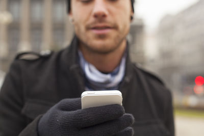 Portrait of young man using mobile phone
