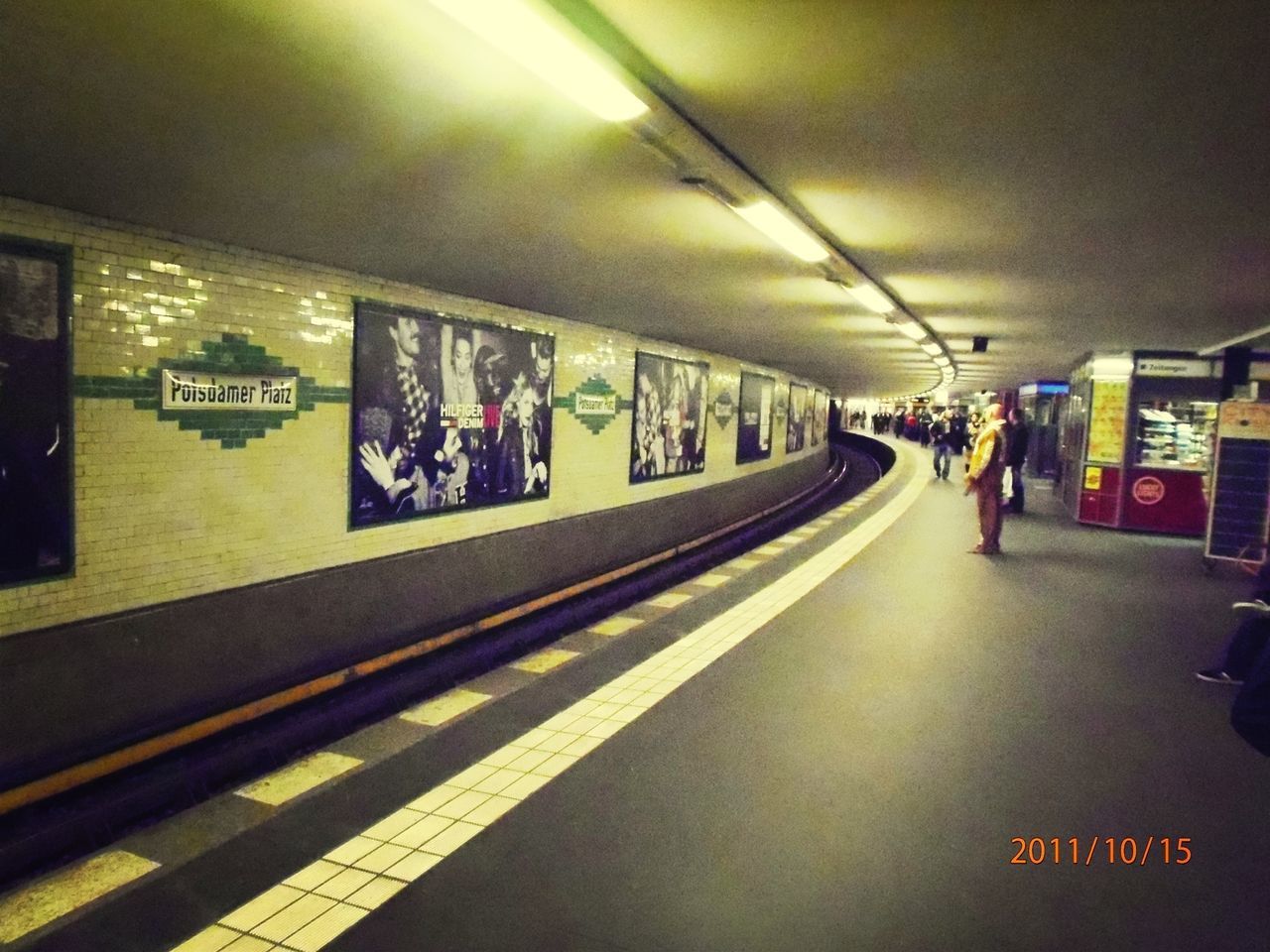 transportation, illuminated, public transportation, railroad station platform, railroad station, text, mode of transport, indoors, rail transportation, subway station, travel, railroad track, incidental people, the way forward, information sign, communication, train - vehicle, night, subway, western script