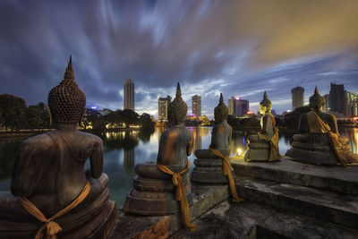 Panoramic view of buildings against cloudy sky