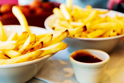 Close-up of fries and yellow bowl on table