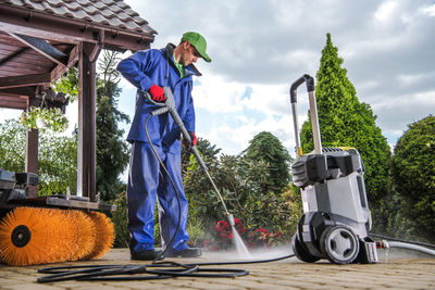 Man spraying water while standing outdoors