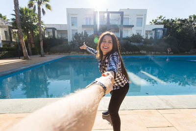 Portrait of happy young woman in swimming pool