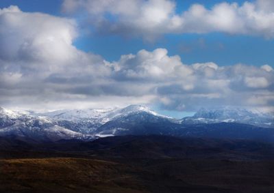 Scenic view of mountains against cloudy sky