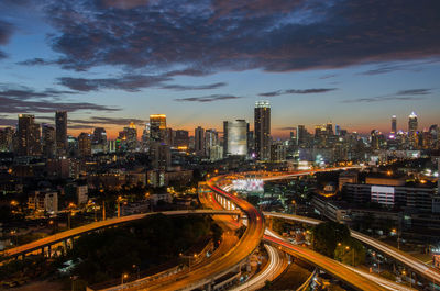 High angle view of illuminated city against sky at night