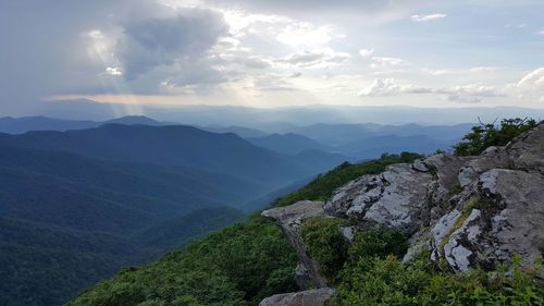 Scenic view of mountains against cloudy sky