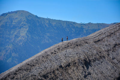 Tourists hiking on the slopes of mt bromo crater