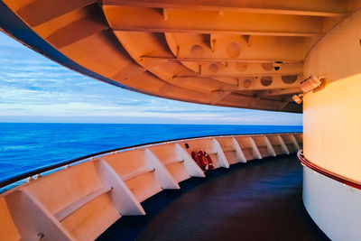 Ship sailing in sea against sky at dusk