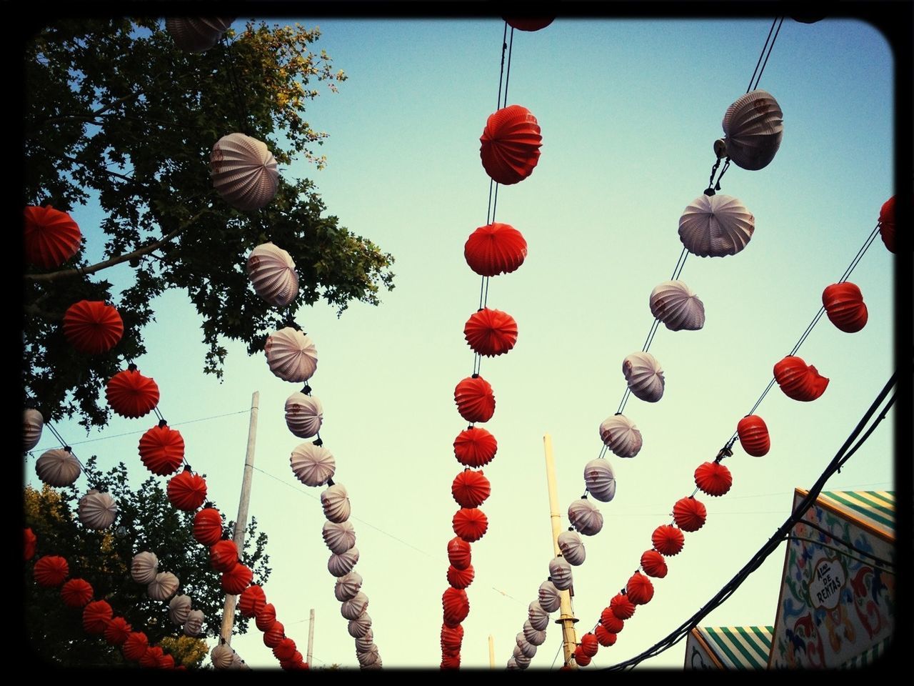 low angle view, hanging, decoration, sky, celebration, in a row, multi colored, lighting equipment, auto post production filter, tradition, transfer print, cultures, traditional festival, lantern, red, balloon, chinese lantern, abundance, clear sky, no people