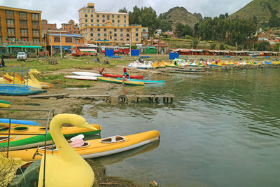 Boats moored in lake against sky