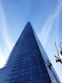 Low angle view of modern building against blue sky