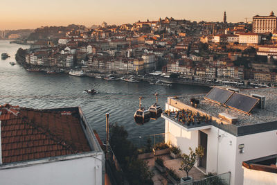 High angle view of town by sea against sky