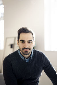 Portrait of businessman sitting in office