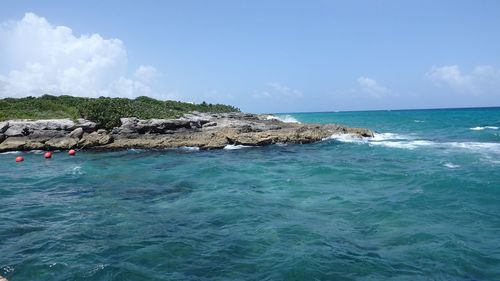 Scenic view of sea against blue sky