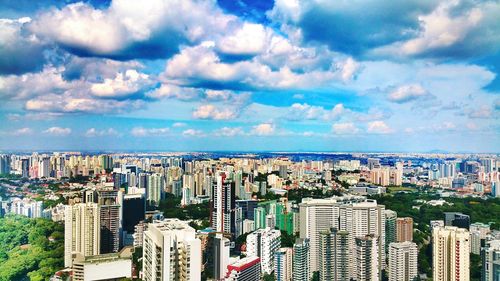 Cityscape against cloudy sky