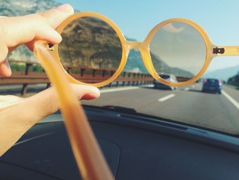 View of road seen through sunglasses