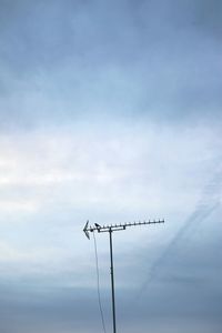 Low angle view of telephone pole against sky