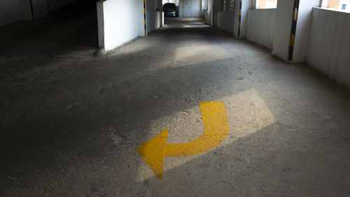 High angle view of arrow sign on road in building