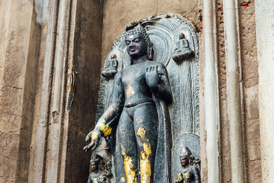 Low angle view of statue against temple